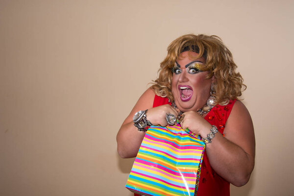 Funny travesty actor. Drag queen and gift.