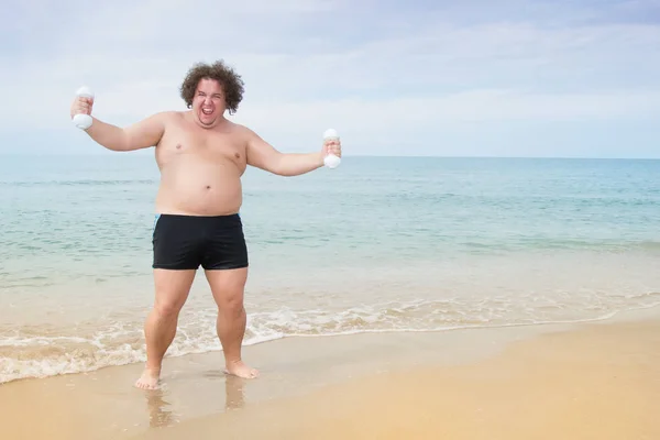 Funny fat man on the sea. Training and healthy lifestyle