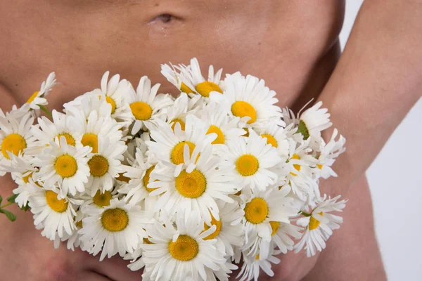 Handsome man and flowers. Love and romance. Naked man holding a flowers.