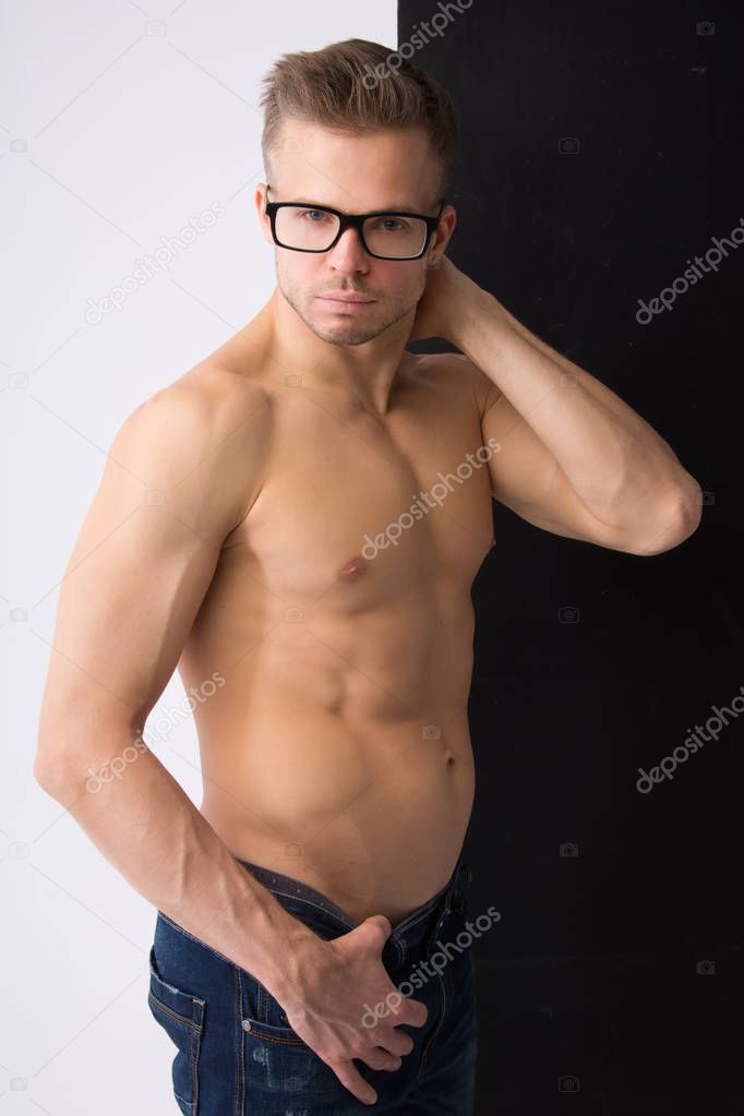 Young handsome man is resting. Smart, muscular and sexy. Contrast background