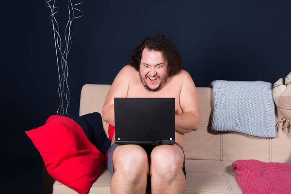 Смешной толстяк и ноутбук.