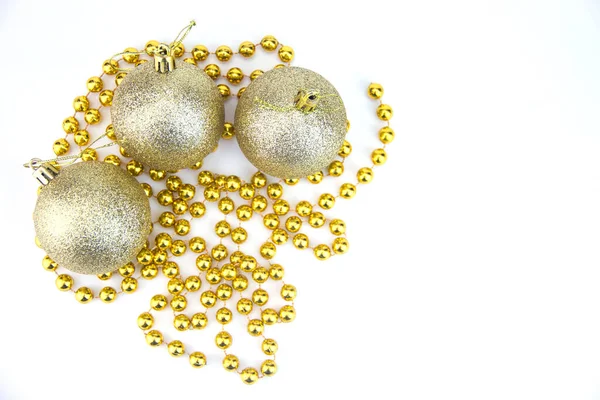 Golden Christmas balls on a white background. Christmas background. Golden sparkling Christmas balls on a white background with a copy of the space Stock Picture