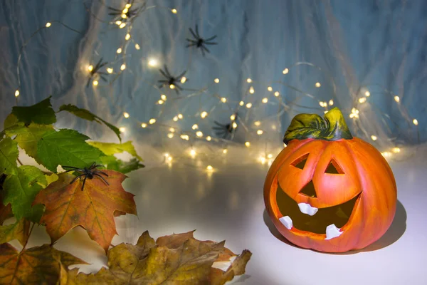 Halloween pumpkin head jack lantern with burning candles over wooden background. Halloween holidays art design, celebration. Carved Halloween Pumpkins with burning candles