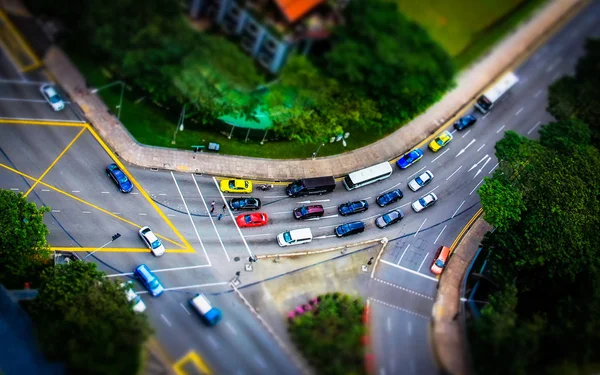 Cars Traveling Through a Busy Traffic Intersection. High Angle View in Singapore.