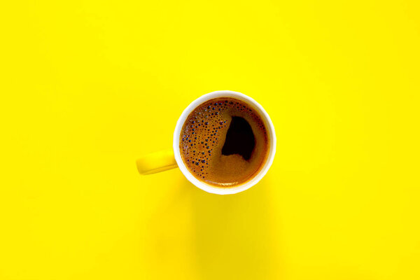 Coffee cup on yellow background.