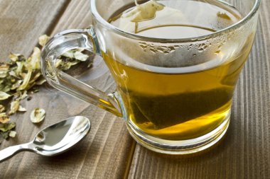 Ahşap zemin üzerine yeşil çay bardağı