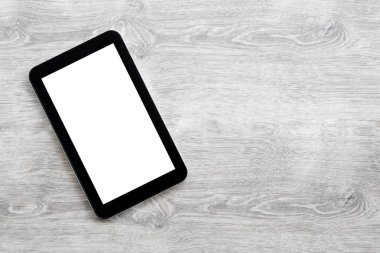 gri bir ahşap zemin üzerinde dijital tablet