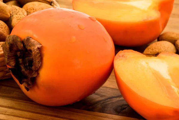 Delicious Fresh Persimmon Fruit Almond Nuts Wooden Table — Stock Photo, Image