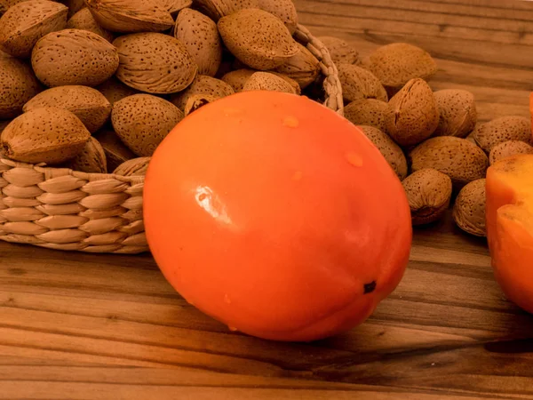 Delicious Fresh Persimmon Fruit Almond Nuts Wooden Table — Stock Photo, Image