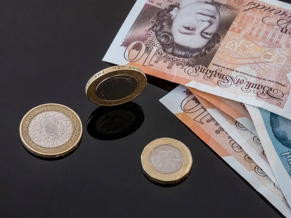 British currency notes  and coins on the glass table