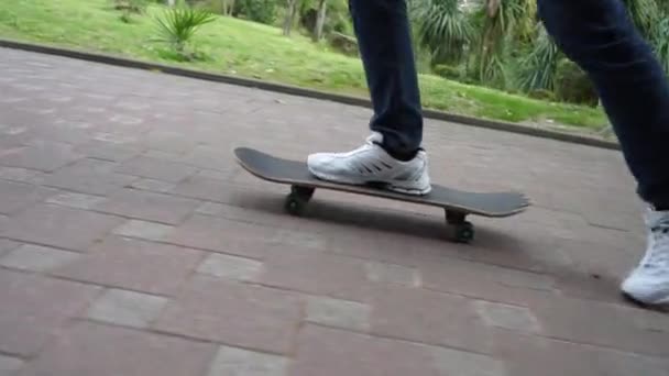 Skateboarder White Sneakers Rides Skateboard Cobblestones — Stock Video