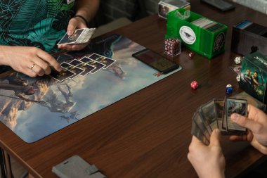İki adam masa oyunu Magic The Gathering oynuyor. Masa oyunu konsepti