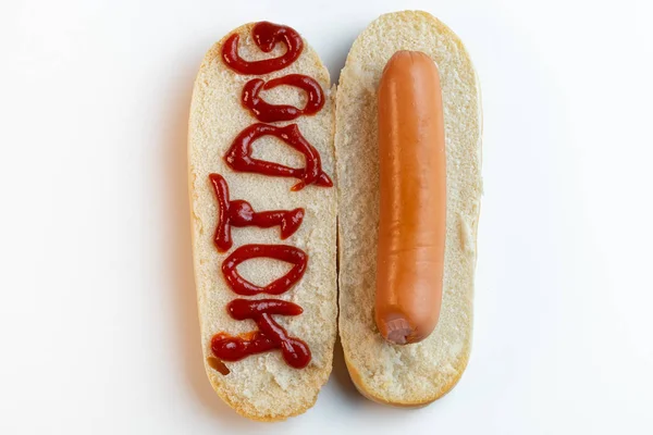 Hot dog bun with sausage on white background. The inscription ketchup Hot-dog. Top view. — Stock Photo, Image