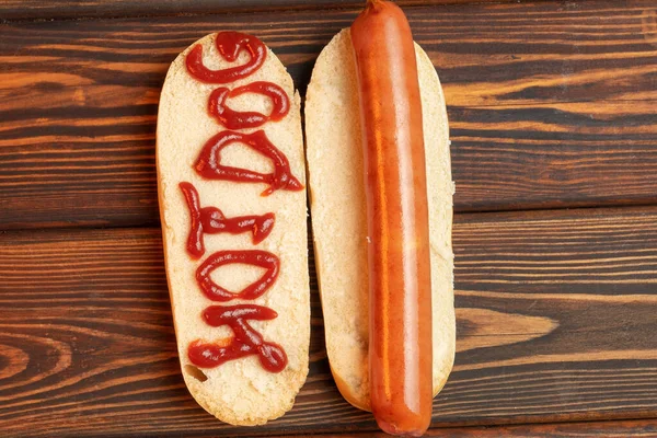 Big hot dog on dark wooden background. Grill-menu — Stock Photo, Image