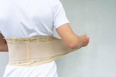 Lumbar corset on the human body. Back brace, orthopedic lumbar, support belt for back muscles