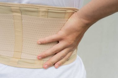 Close up orthopedic lumbar corset on the human body, Back support for muscle back.