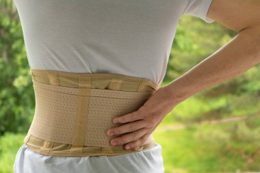 Young teen wearing back support or orthopedic lumbar for protect her spine, medicine and healthy concept