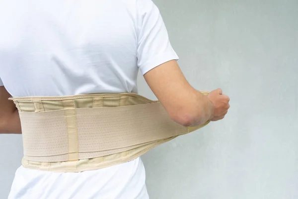 Lumbar corset on the human body. Back brace, orthopedic lumbar, support belt for back muscles