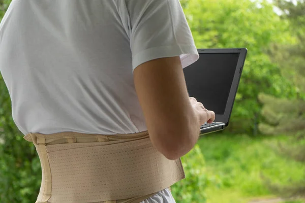 Man Back Brace Lumbar Corset Uses Laptop Background Nature — Stock Photo, Image