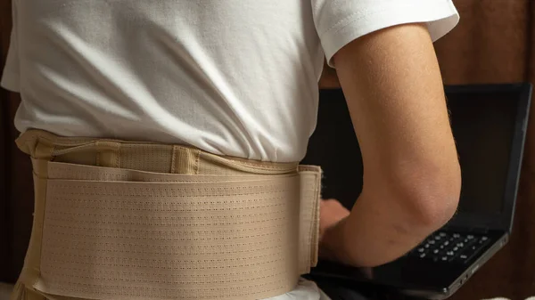 Man Wearing Orthopedic Corset Home Person Laptop Wearing Lumbosacral Brace — Stock Photo, Image