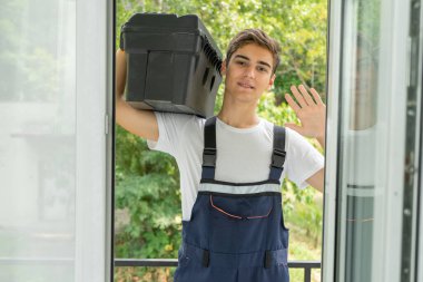 Photo of a young worker in uniform, the concept of an assistant for an hour clipart