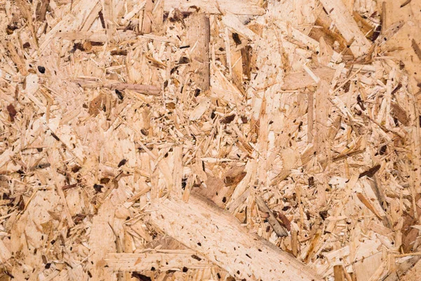 Osbボードは 木製の背景にサンド茶色の木のチップで作られています Osb木のベニヤの背景 タイト シームレスな表面のトップビュー ストランド ボード フレークボード スターリングボード アスペナイト — ストック写真