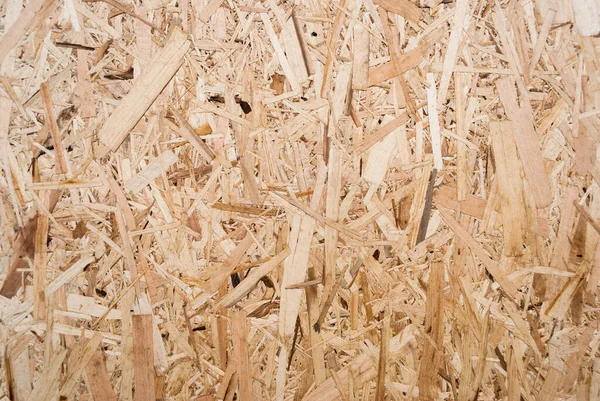 stock image OSB boards are made of brown wood chips sanded into a wooden background. Top view of OSB wood veneer background, tight, seamless surface. Oriented Strand Board. Flake board. Sterling board. Aspenite