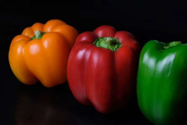 Siyah arkaplanda kırmızı sarı sarı İspanyol biberi