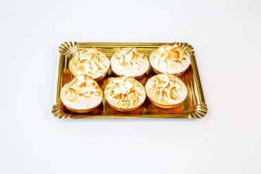 small meringue and cream cake on a white background