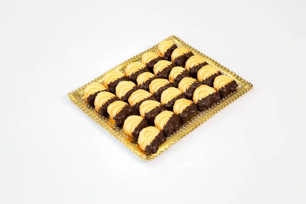 stock image cookies on a gold tray with white background