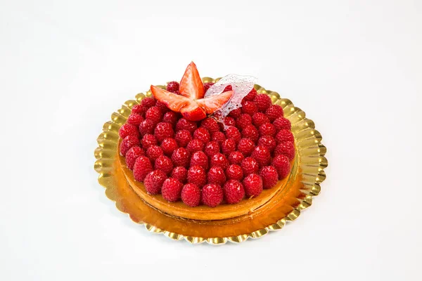 beautiful raspberry fruit cake on a gold tray on white background