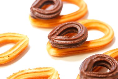 Beyaz arka plan üzerinde üstte küçük çikolatalı börek ile İspanyol börek