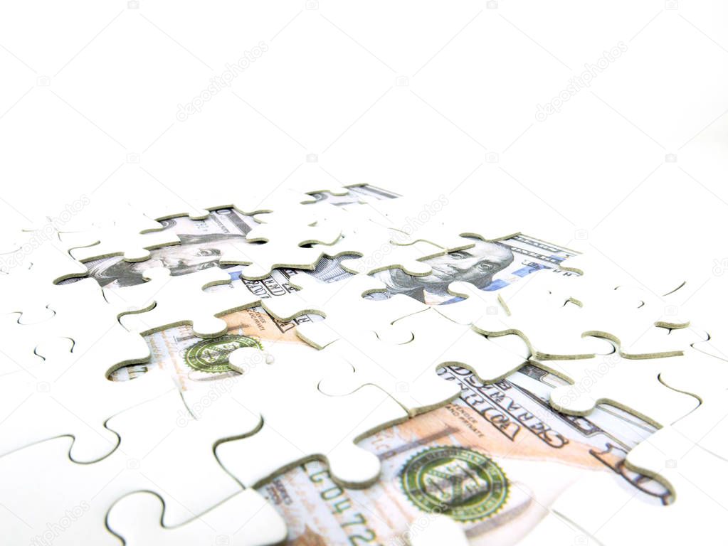 Missing jigsaw puzzle pieces on 100 Dollar money background, Key for Business solution success concept.
