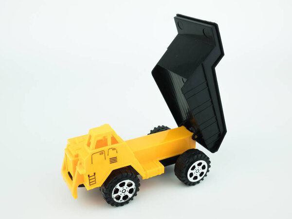 Toy Dump truck on white background, Engineering construction concept.