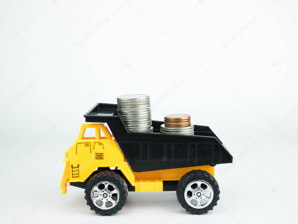 Toy lorry with coins on white background, Business concept.