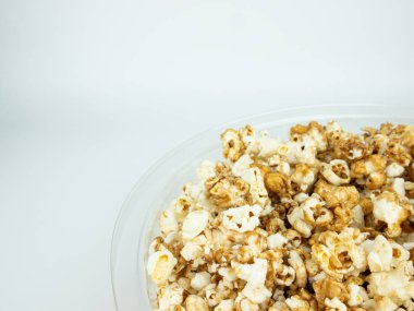 Beyaz arka plan üzerinde kase patlamış mısır.