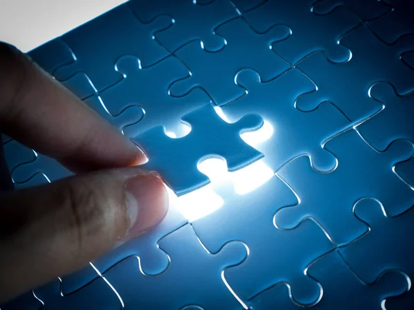 Missing Jigsaw puzzle piece with lighting, business concept for completing the finishing puzzle piece.