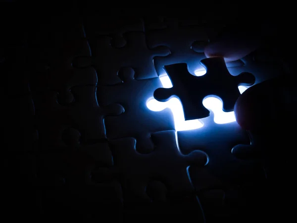 Missing Jigsaw puzzle piece with lighting, business concept for completing the finishing puzzle piece.