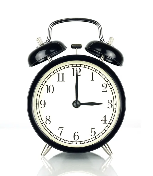 Alarm Clock isolated on white, in black and white, showing three o'clock.