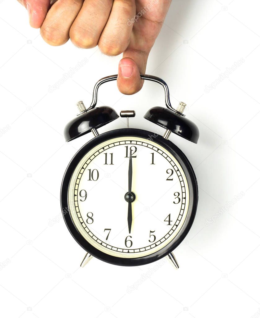 Hand holding a clock, on a white background.