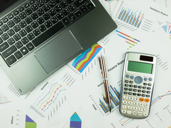 Business report chart and Financial graph analysis with notebook, calculator and pen on table.