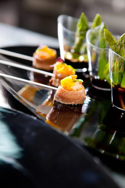 stock image Anchovy and mango skewers with green asparagus