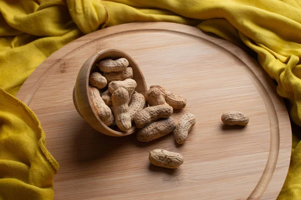 Walnuts kernels on dark desk, Whole walnut in wood vintage bowl, Nuts in bamboo wooden bowl, walnuts in wood bamboo bowl