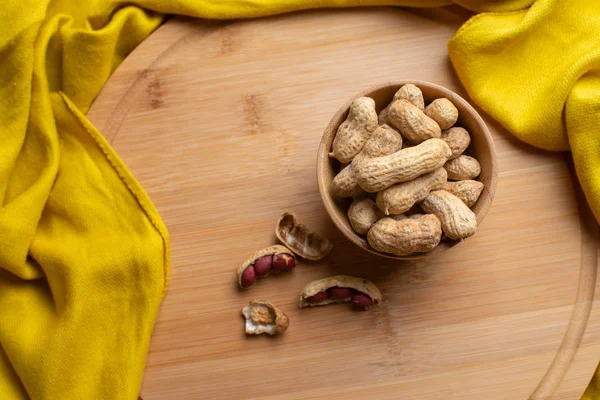 Walnuts kernels on dark desk, Whole walnut in wood vintage bowl, Nuts in bamboo wooden bowl, walnuts in wood bamboo bowl