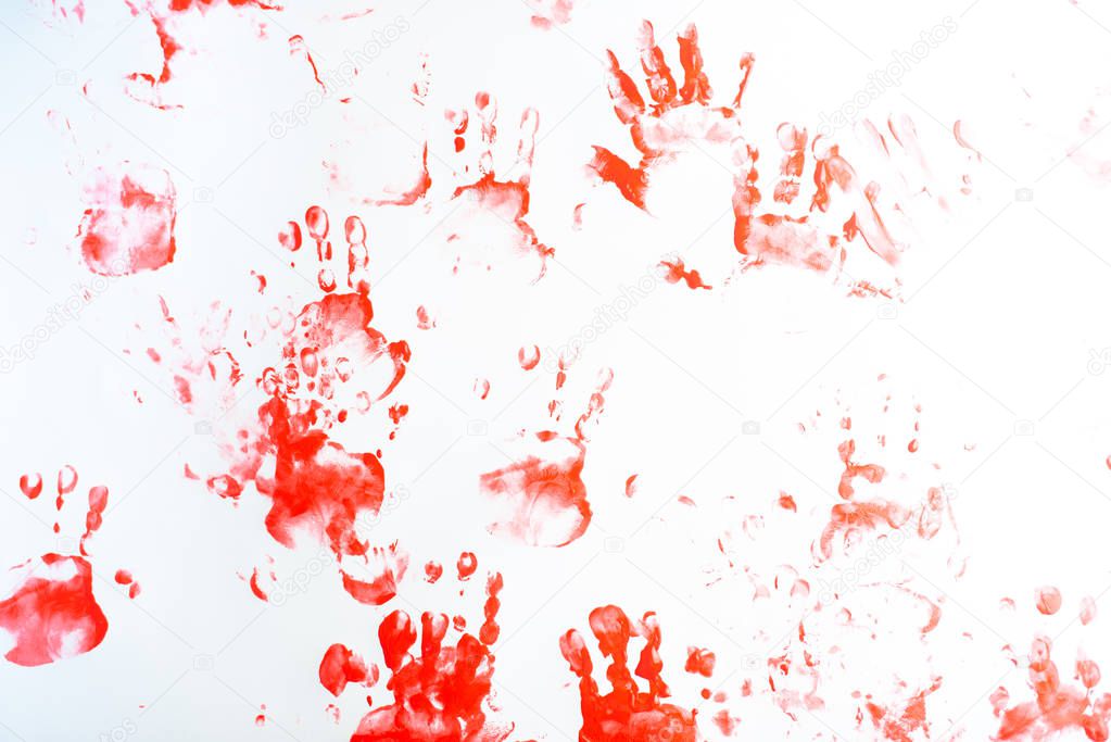 Hands of a little boy painting with watercolors on white paper s