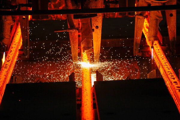 Steel billets at torch cutting in metallurgical plant. Metallurgical production, heavy industry, engineering, steelmaking.