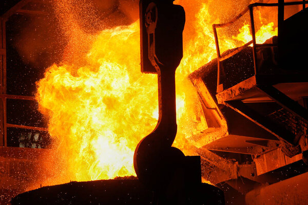 Steel production in electric furnaces. Sparks of molten steel. Electric arc furnace shop EAF. Metallurgical production, heavy industry, engineering, steelmaking