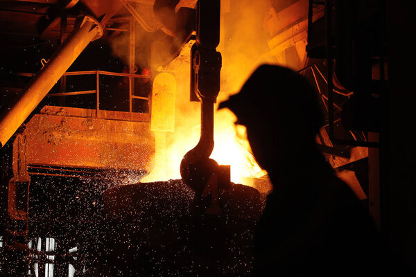 Steel production in electric furnaces. Sparks of molten steel. Electric arc furnace shop EAF. Metallurgical production, heavy industry, engineering, steelmaking