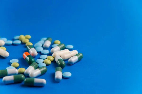 Coronavirus 2019-nCoV salgını. Hap ve ilaç, hastalık sırasında bakım. Mavi arkaplan.