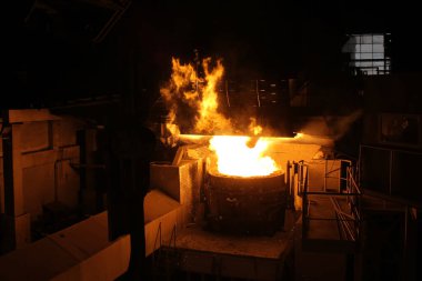Elektrikli fırınlarda çelik üretimi. Erimiş çelikten kıvılcımlar. Elektrikli ark fırını EAF. Metalurjik üretim, ağır sanayi, mühendislik, çelik yapımı.